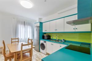 a kitchen with a table and a dining room at Lujan 6f Entre Sueños Y Realidad in Puntallana