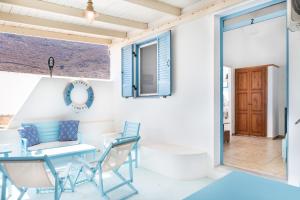 a dining room with a blue table and chairs at Beachfront Lampis Dolphin 2 in Skala