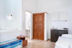 a bedroom with two beds and a bathroom with a sink at Beachfront Lampis Dolphin 2 in Skala +23 photos