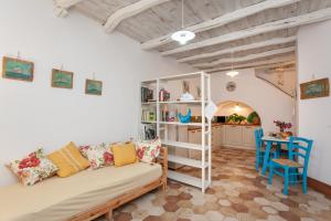 a living room with a couch and a table at Domo Bangone in Orosei