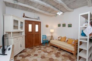 a living room with a couch and a bunk bed at Domo Bangone in Orosei