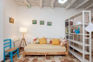 a bedroom with a bed and a book shelf at Domo Bangone in Orosei