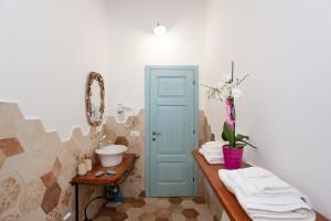 a bathroom with a sink and a counter with towels at Domo Bangone in Orosei +17 photos