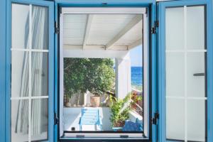 a window view of the ocean from a house at Beachfront Lampis Dolphin 2 in Skala