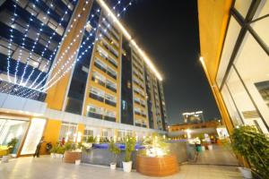 a building with lights on the side of it at night at Lux 1bhk with balcony in Noida