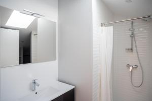 a white bathroom with a shower and a sink at Villa Surf and Golf in Messanges +35 photos
