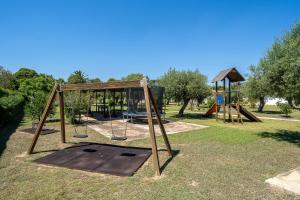 a park with a swing set and a playground at Complejo Colibri 13 in Cambrils