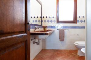 a bathroom with a sink and a toilet at Apartment Ida Isuledda 2 in San Teodoro +10 photos