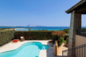 a swimming pool with a view of the ocean at Apartment Ida Isuledda 2 in San Teodoro