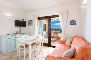 a living room with a couch and a table at Bia de Bados B5 in Olbia +12 photos