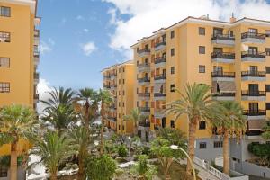 a view of apartment buildings with palm trees at Casa Roberto in Candelaria