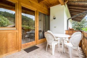 a patio with a table and chairs on a porch at Apartment Ida - Obermösslhof in Lana