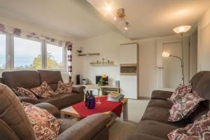 a living room with two couches and a table at Ferienwohnung Steinhilber 1 in Eriskirch