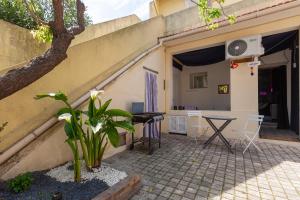 a patio of a house with a table and chairs at Love Room avec Balnéo in Toulon
