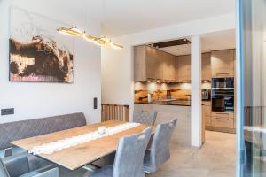 a kitchen and dining room with a wooden table and chairs at Ferienwohnung Elsa in Fliess
