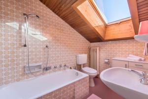 a bathroom with a tub and a toilet and a sink at Villa Soldanella in Ortisei +21 photos