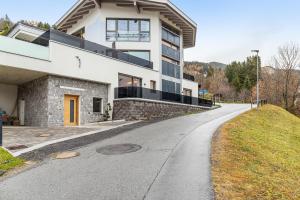 a house on a hill with a winding road at Ferienwohnung Elsa in Fliess
