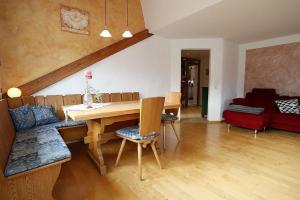 a living room with a table and a couch at Haus Reichenbach in Glottertal