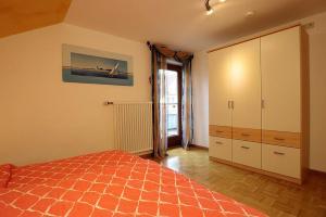 a bedroom with a bed and a large closet at Haus Reichenbach in Glottertal