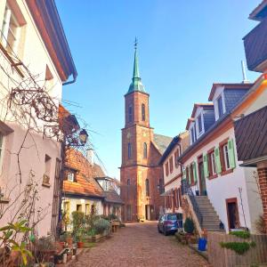 a church with a steeple in the middle of a street at Charming House in Neckargemünd +14 photos