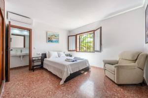 a bedroom with a bed and a couch and a chair at Ca Nostra Ibiza in Sant Josep de sa Talaia +17 photos