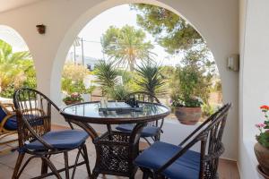 a patio with a glass table and chairs at Ca Nostra Ibiza in Sant Josep de sa Talaia
