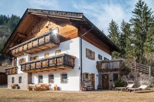 a large house with wooden balconies on top of it at Thomasegg Hof Linde in Sarntal