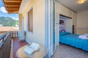 a bedroom with a bed and a glass table at Liver 203 in Tremosine Sul Garda