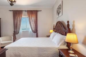 a bedroom with a white bed and a window at Casa Da Jesus in Provesende +36 photos