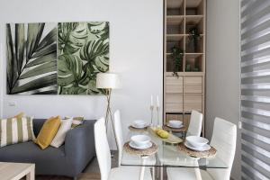 a living room with a glass table and a couch at Urban Park Aloe in Los Llanos de Aridane +10 photos
