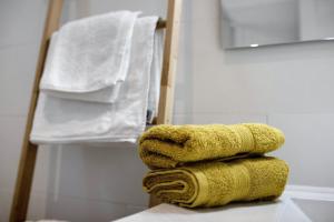 a stack of towels on a table in a bathroom at Urban Park Aloe in Los Llanos de Aridane