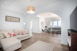 a living room with a white couch and a table at Villa Domus Alba A - B in Felanitx