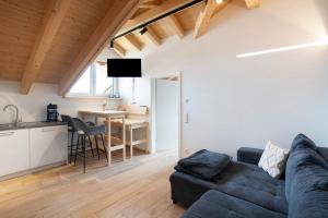 a living room with a couch and a table at Ferienwohnung Wendelsteinblick in Bad Tölz