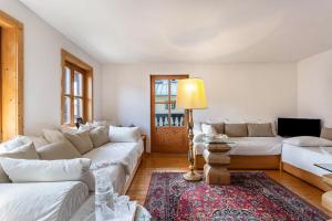 a living room with white couches and a rug at Ferienappartement 1 - Lockstein in Berchtesgaden