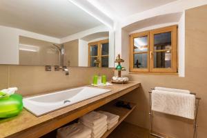 a bathroom with a large tub and a sink at Ferienappartement 1 - Lockstein in Berchtesgaden +13 photos