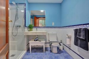 a bathroom with a toilet and a sink and a shower at Oasis Royal F306 in Corralejo +23 photos