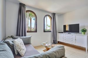a living room with a couch and a tv at Oasis Royal F306 in Corralejo