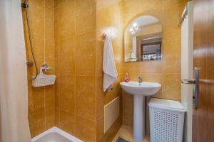 a bathroom with a sink and a toilet and a mirror at Paraíso da Rocha in Portimão +16 photos
