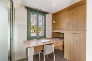 a room with a wooden desk and a window at Sa Verdal in El Port de la Selva +17 photos