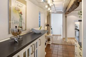 a kitchen with a black counter and a sink at Ferienwohnung Gill in Staufen im Breisgau