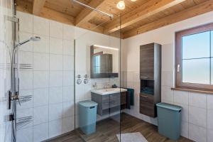 a bathroom with a shower and a sink at Ferienwohnung Rupertiwinkl in Teisendorf +13 photos