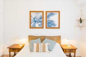 a bedroom with a bed with two night stands at Palmera Beach House in Cullera