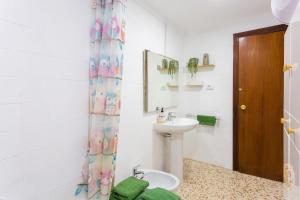 a white bathroom with a toilet and a sink at Palmera Beach House in Cullera +24 photos