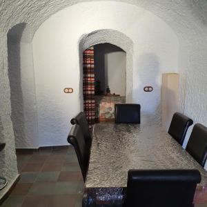 a meeting room with a table and chairs in a building at Cueva de Manuel in Guadix +11 photos
