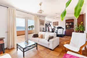 a living room with a white couch and a table at La Gola in La Manga del Mar Menor