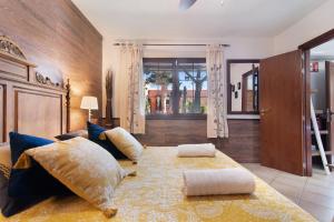 a bedroom with a large bed with pillows on it at Villa La Quinta de Vals in Valsequillo +31 photos
