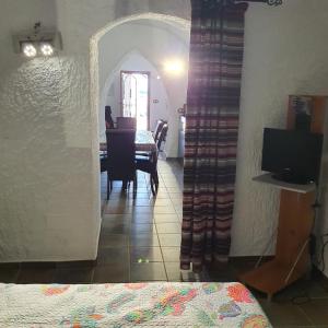 a room with a table and a dining room at Cueva de Manuel in Guadix