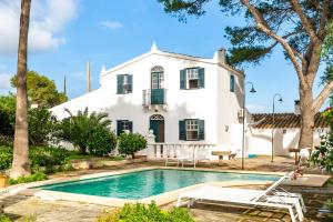 a house with a swimming pool in front of a house at Villa Torret 46 in Sant Lluis