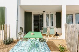 a green table in front of a house at La Plage, Rivedoux Beach House in Rivedoux-Plage +18 photos
