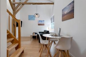 a small dining room with a table and chairs at Ferienwohnung Junge 1 in Lohe-Rickelshof